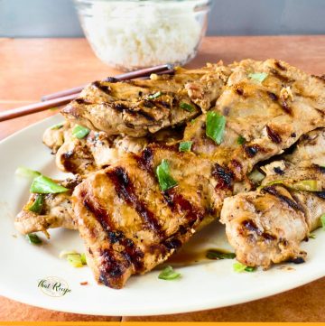 Grilled Asian style pork riblets on a plate with text overlay.