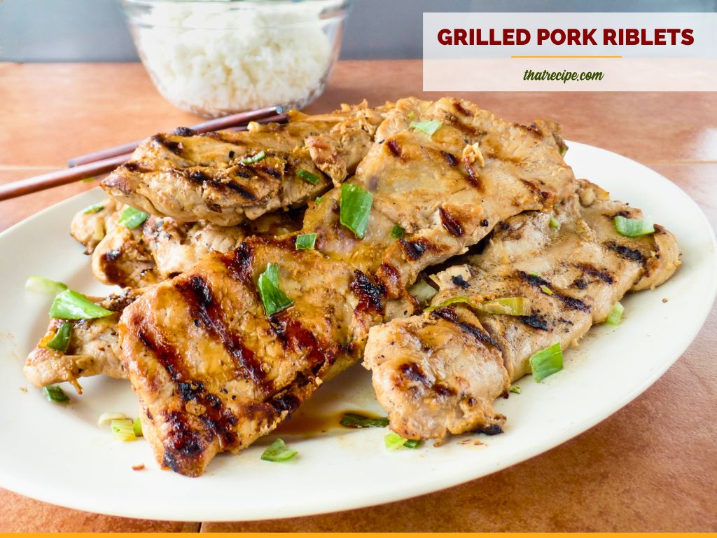 Grilled Asian style pork riblets on a plate with text overlay.