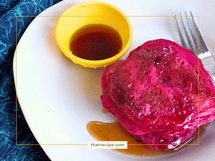 pink pancakes on a plate with syrup
