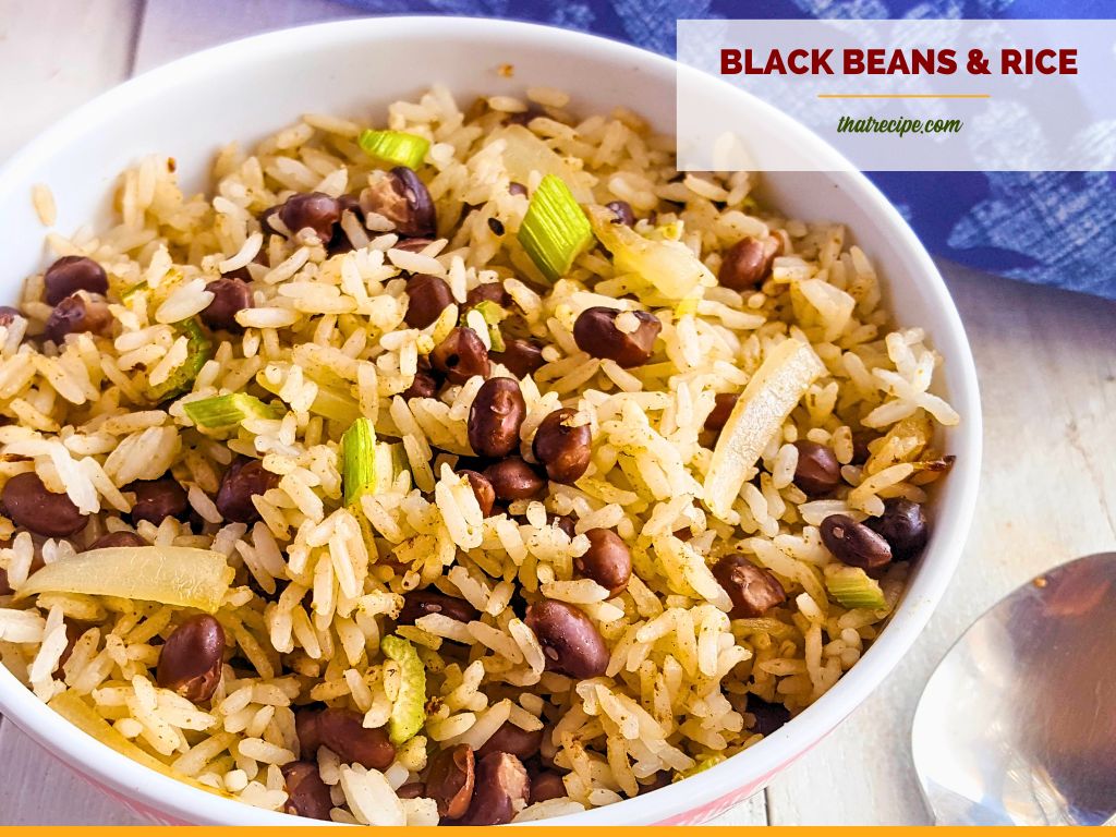 bowl of black beans and rice on white wood background with blue cloth