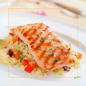 grilled salmon on a plate with couscous