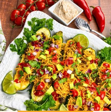 stuffed zucchini with ground beef, cheese, onion, avocado and tomatoes