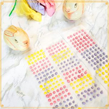 candy buttons (candy dots) with decorative rabbits on a marble background