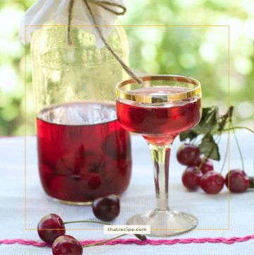 cherry liqueur in a cup and a bottle