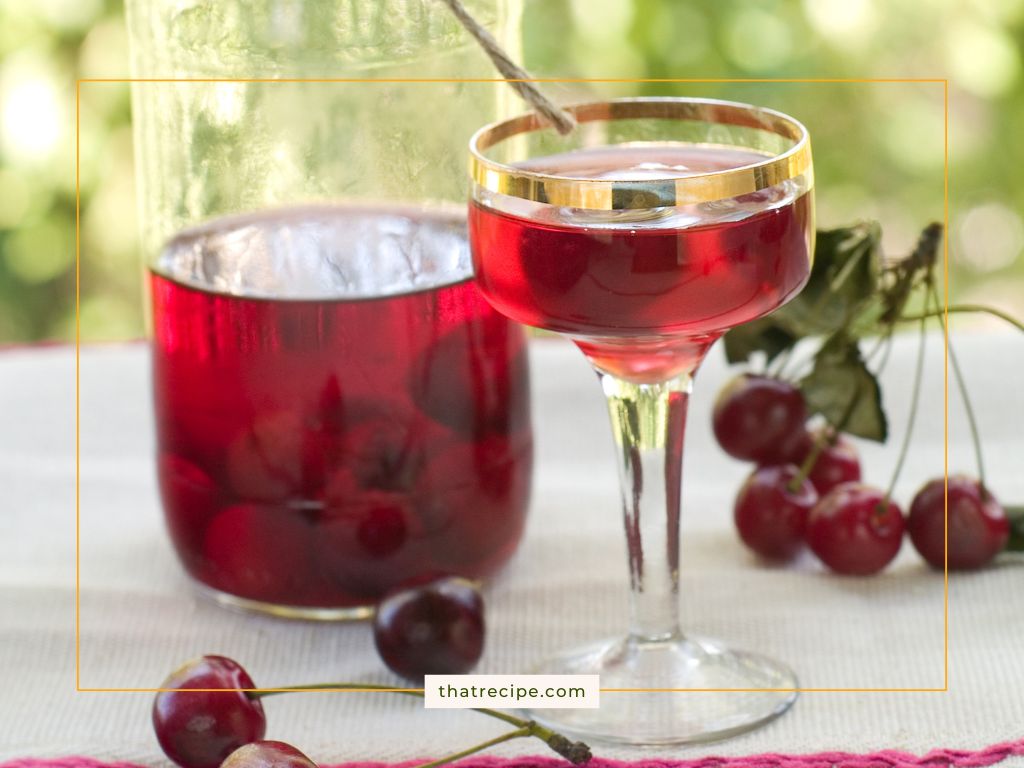 cherry liqueur in a cup and a bottle
