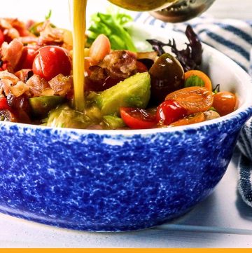 salad on a plate with text overlay "chicken, bacon and avocado salad"