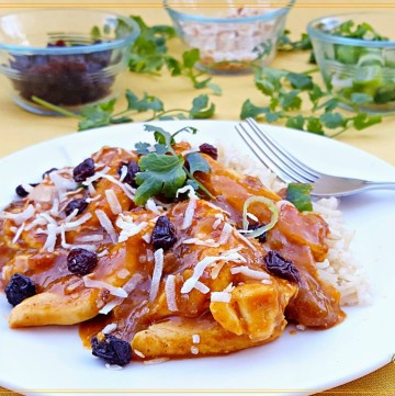 chicken curry on a plate with condiments
