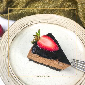 Chocolate cheesecake with chocolate topping and fresh strawberry slice