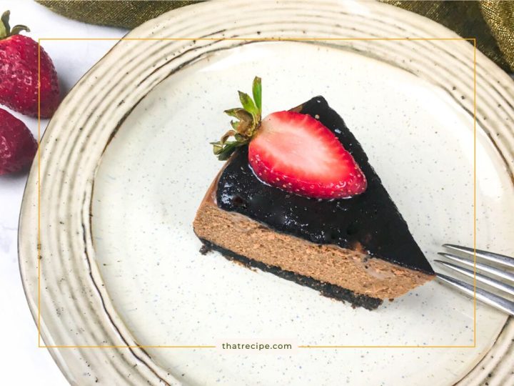 Chocolate cheesecake with chocolate topping and fresh strawberry slice