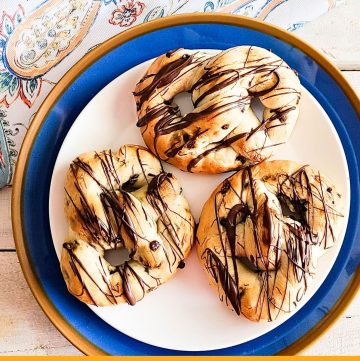 chocolate drizzled chocolate chip pretzels on a plate