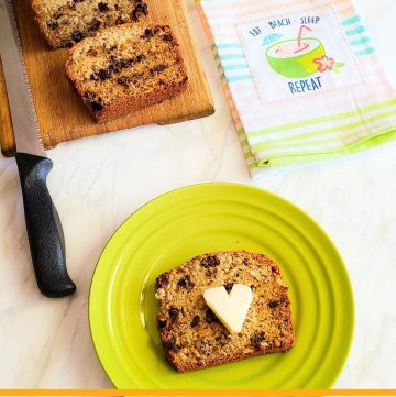 slice of chocolate pecan banana bread with loaf of bread