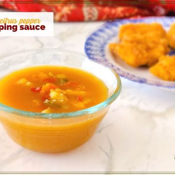 bowl of orange sauce with text overlay "citrus pepper dipping sauce"