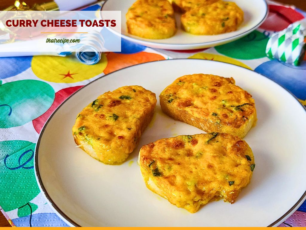 mini cheese appetizers on a plate with text overlay "Curry Cheese Toasts"