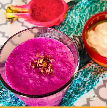 top down view of dragon fruit lassi with half dragon fruit and yogurt