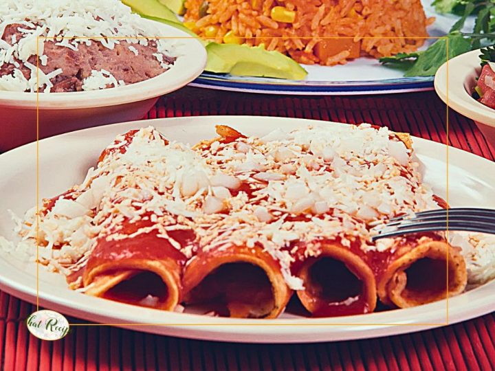 plate of red enchiladas with other Mexican foods.