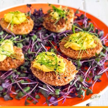 fried deviled eggs on bed of microgreens
