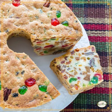 Sliced fruitcake on a plate with text overlay "moist and delicious fruitcake"