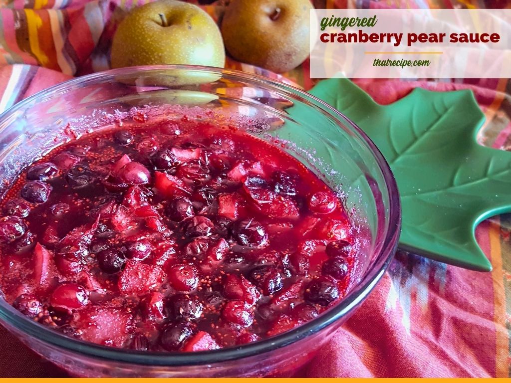 bowl of gingered cranberry pear sauce on a table with Asian pears
