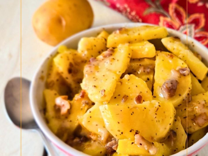 Hot German Potato Salad in a dish (sliced potatoes with creamy bacon sauce)