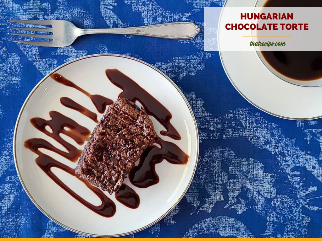 slice of chocolate torte on a plate drizzled in chocolate sauce with text overlay "Hungarian chocolate torte"