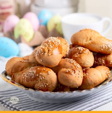 orange cookies on a plate with text overlay "Koulourakia Greek Easter Cookies"