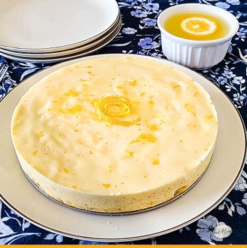 homemade cheesecake on a plate with text overlay "lemon ricotta cheesecake"