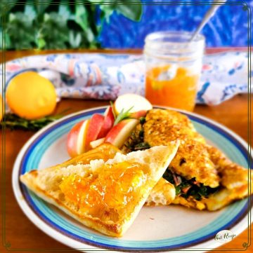 toast on a plate with an omelet and apples
