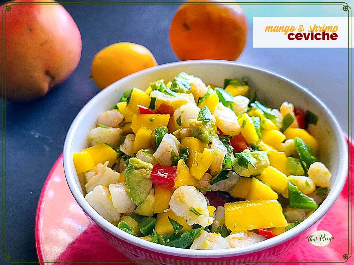 bowl of ceviche with text overlay "mango and shrimp ceviche"