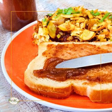 knife spreading apple butter on a piece of toast
