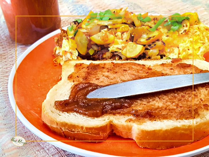 knife spreading apple butter on a piece of toast