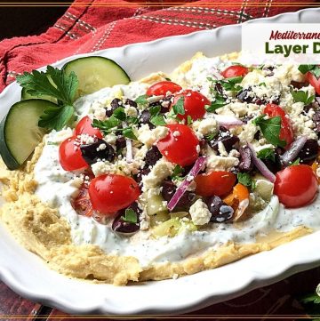 Layered hummus dip with text overlay "Mediterranean Layer Dip"