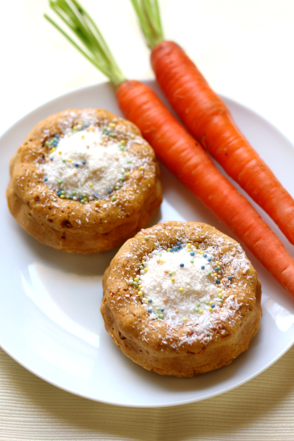 Mini Carrot Cake Bundts | Strength and Sunshine @RebeccaGF666 Personal mini carrot cake bundts for you and a friend! Easy, gluten-free, vegan cakes with a center stuffed with "cream cheese" frosting and decorated with coconut and sprinkles! Have your cake and eat it too! Easter dessert was never so sweet (but sugar-free!)!