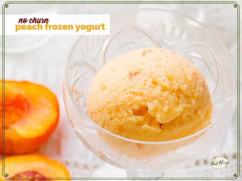 peach yogurt in a glass dish with cut fresh peach next to it and text overlay "no churn peach frozen yogurt"