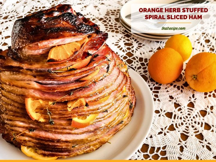 Spiral sliced ham on a plate with text overlay "orange stuffed spiral sliced ham"