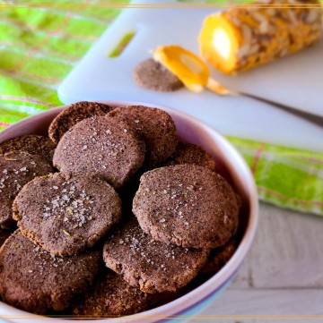homemade crackers in a bowl with text overlay homemade pecan meal crackers