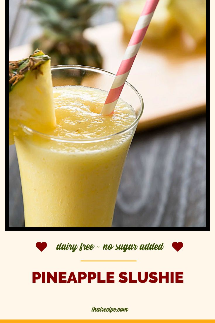 pineapple slushie on a table with fresh pineapple