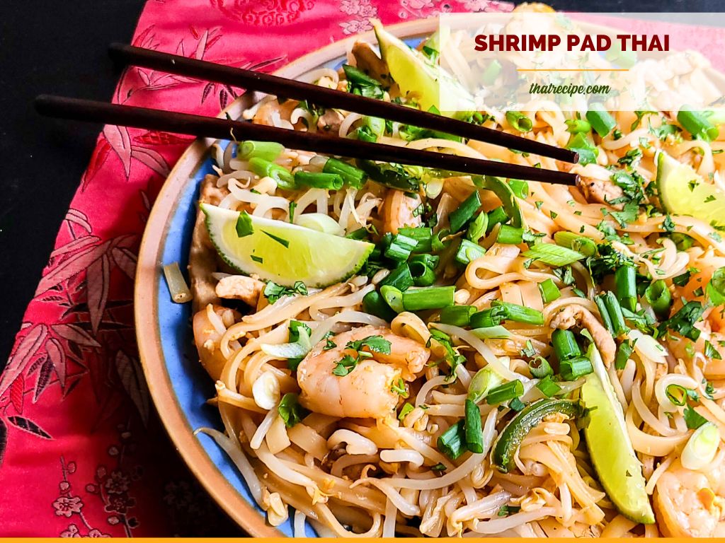 top down view of noodles with shrimp and text overlay "pork and shrimp pad thai"