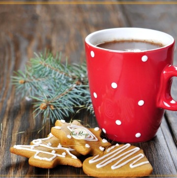 mug of cocoa with with cookies on a table