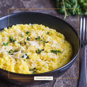 risotto in a bowl topped with Parmesan cheese and herbs
