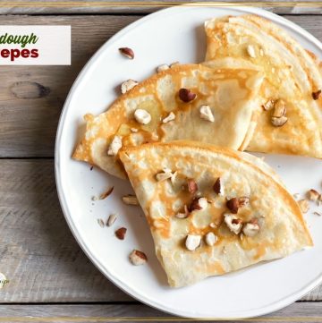 top down view of crepes on a plate with text overlay "sourdough crepes"