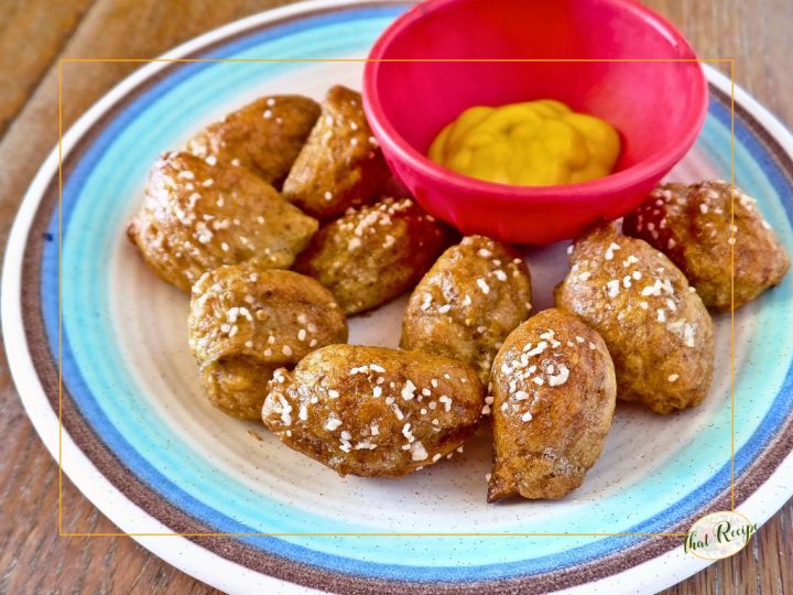 soft pretzel bites on a plate with mustard dip