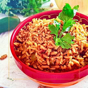 spanish rice in a bowl on the table with onion pepper and cilantro