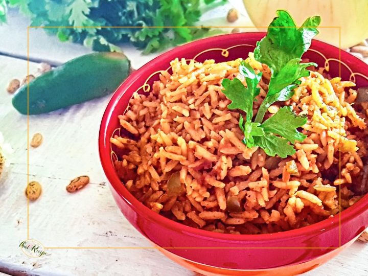 spanish rice in a bowl on the table with onion pepper and cilantro