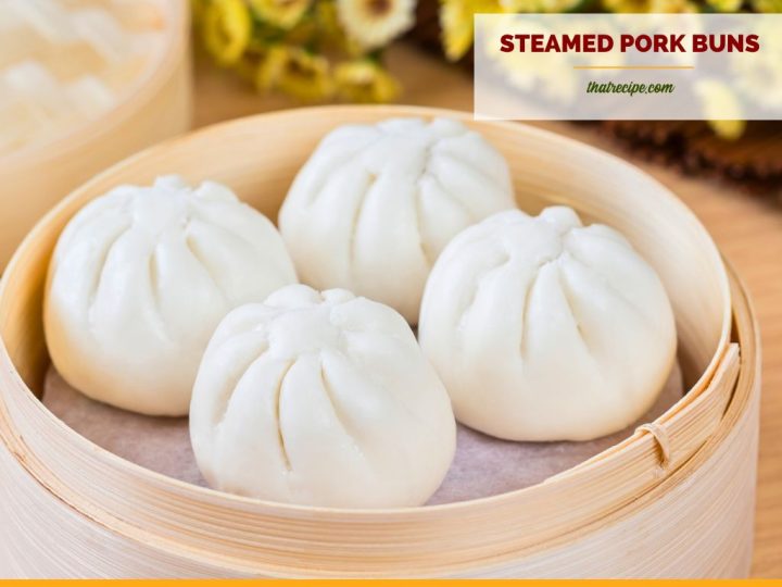 pork buns in a bamboo steamer with text overlay "steamed pork buns"