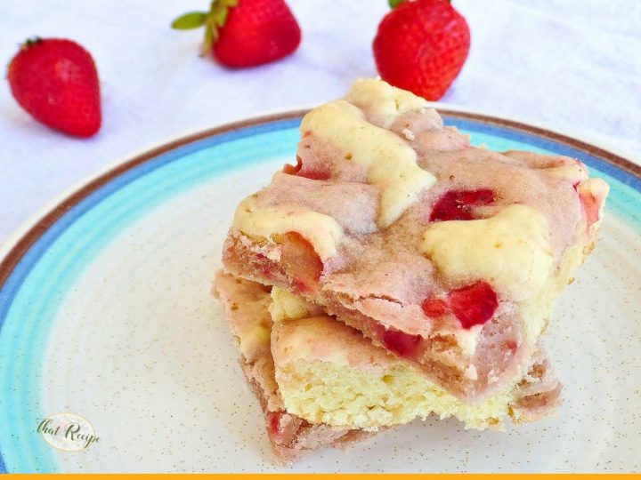 strawberry cream cheese swirl cookie bars on a plate