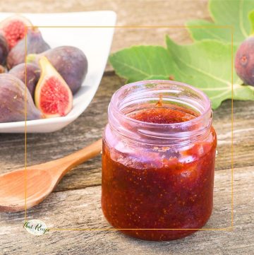 strawberry fig jam in a jar on a table with fresh figs