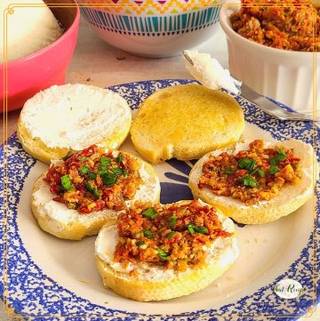 crostini on a plate with text overlay "sun dried tomato tapenade crostini"