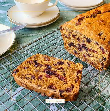 loaf of Tea Brack, a fruit studded quick bread on a cooling rack