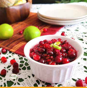 bowl of cranberry sauce on a table with text overlay "tequila lime cranberry sauce"