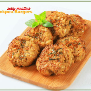 garbanzo bean burger patties on a wooden board with text overlay "Zesty meatless chickpea burgers"